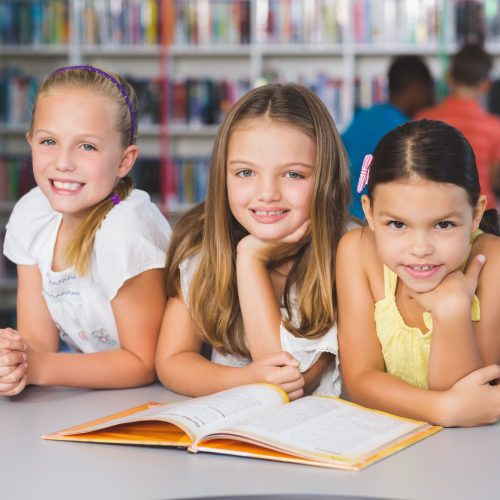 school-kids-reading-book-together-in-library.jpg